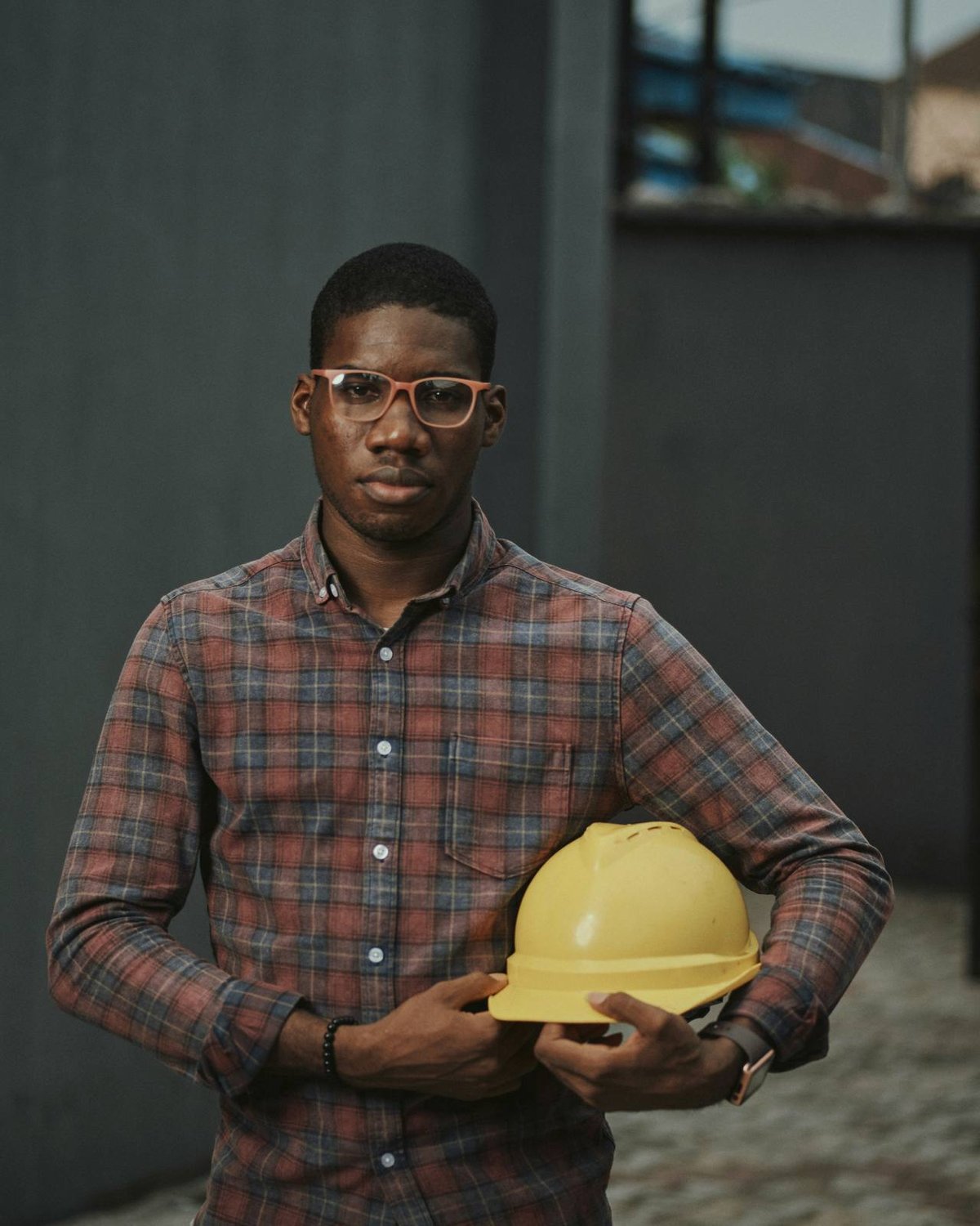 A builder in a plaid shirt on site