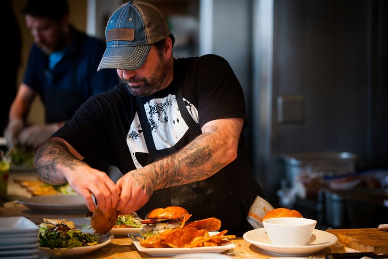 A cook plating food in a restaurant kitchen