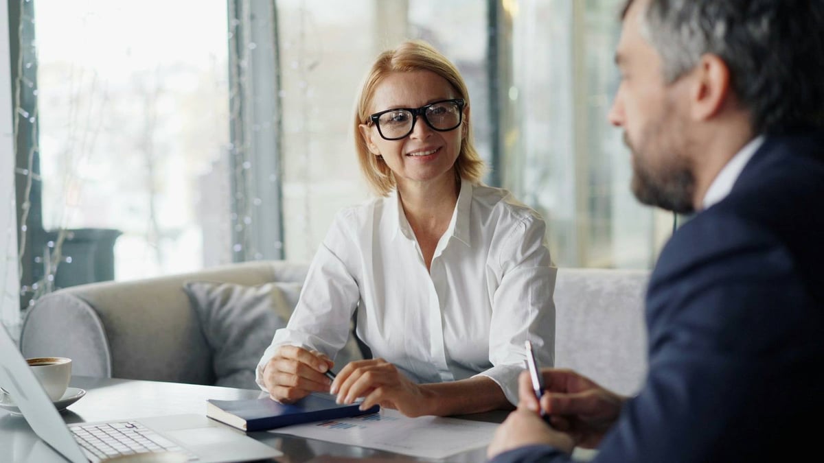 A partner taking notes across the table from a client