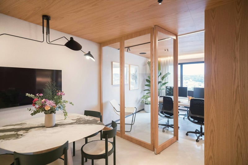 A meeting room behind an oak-and-glass wall