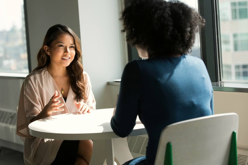 A partner meeting a client at a round table
