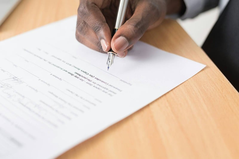A fountain pen signing a printed return