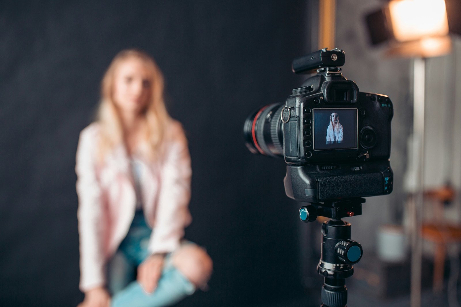 Camera on a tripod in a darkened studio