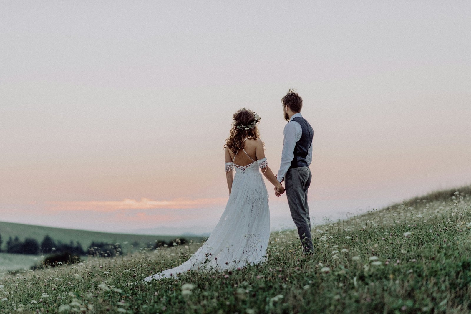 Bride and groom standing in a meadow