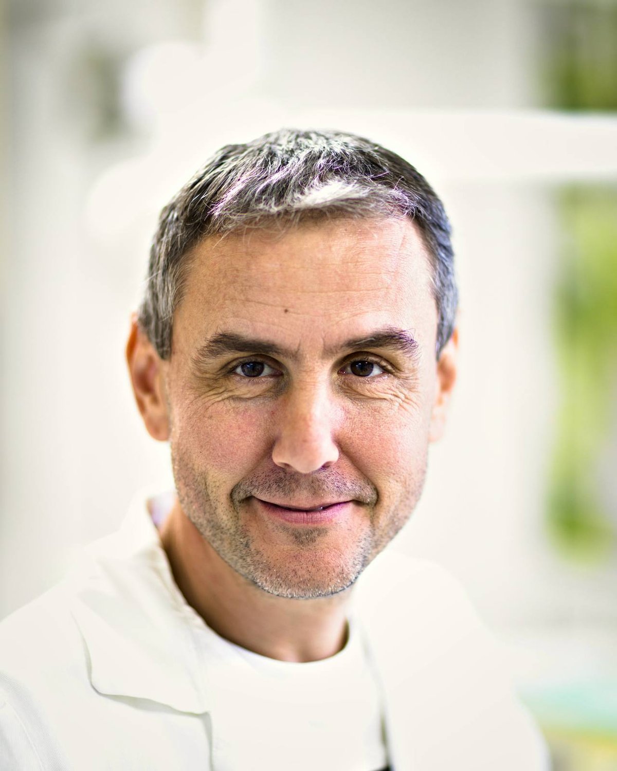 Dr. Ryan Walsh in a white coat at his practice