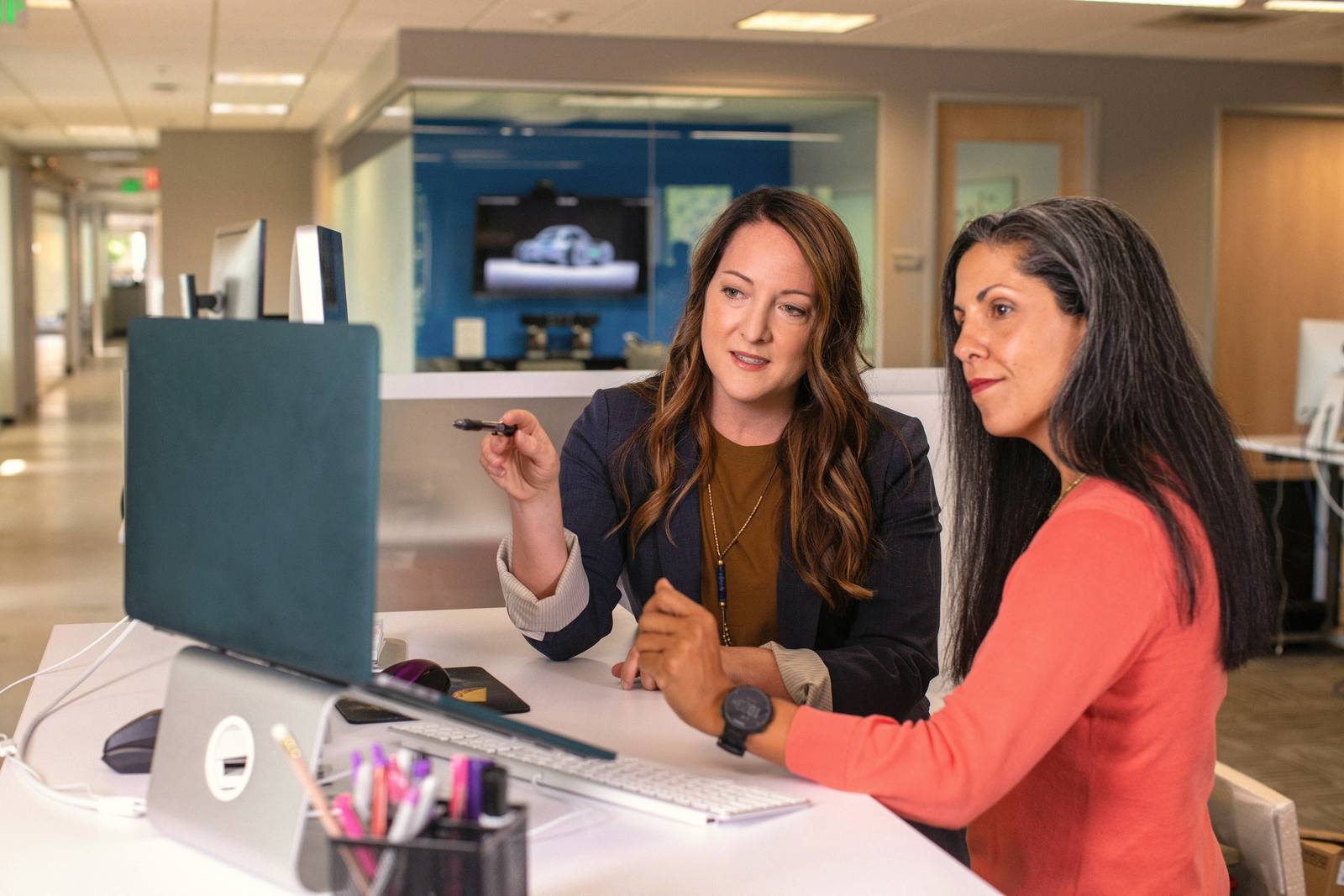 Two women reviewing work together at a desk