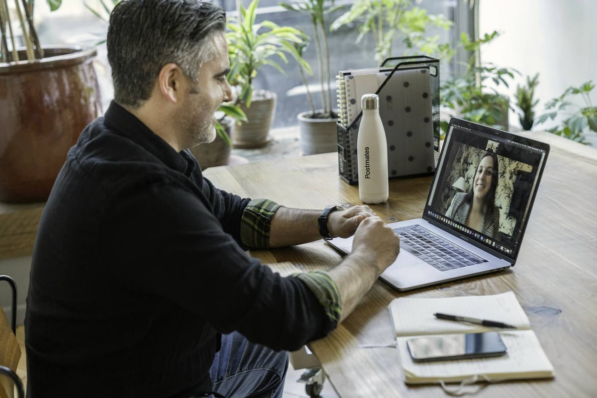 A man reviewing figures on a laptop