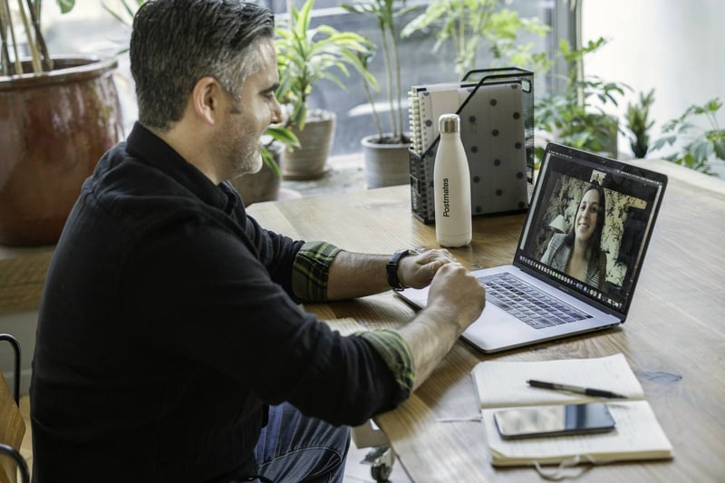 A man reviewing figures on a laptop