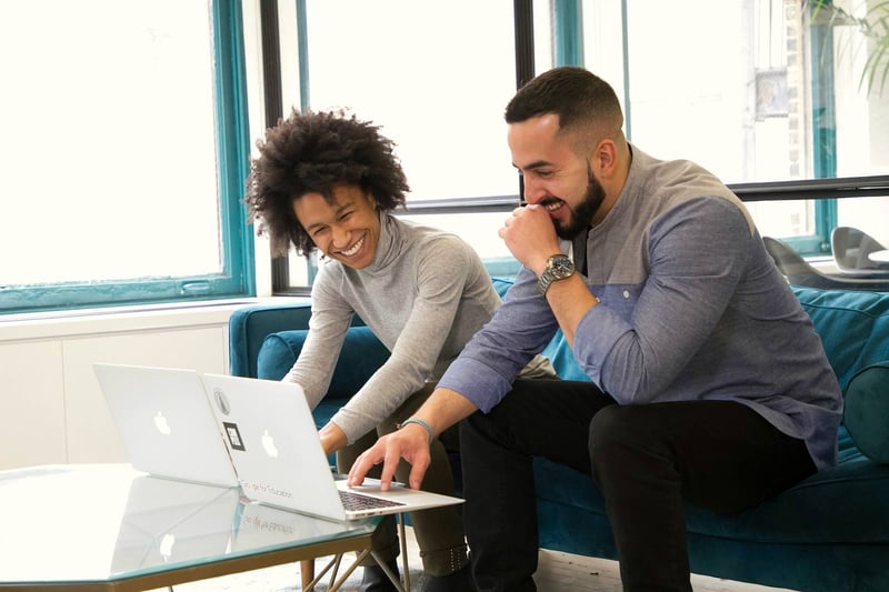 Two colleagues working together at a laptop