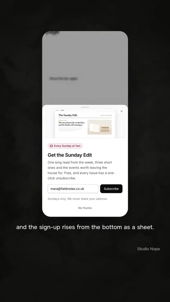 A phone with a newsletter sign-up rising from the bottom of the screen